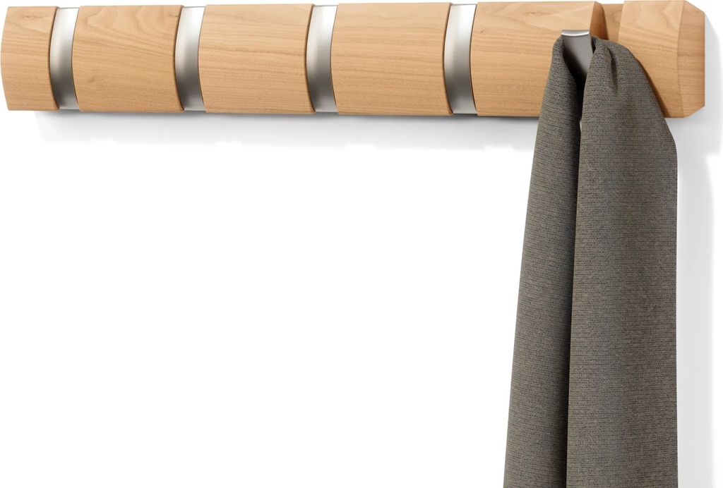 A wooden coat rack with five hooks is mounted on a white wall, with a gray scarf hanging from one of the hooks.