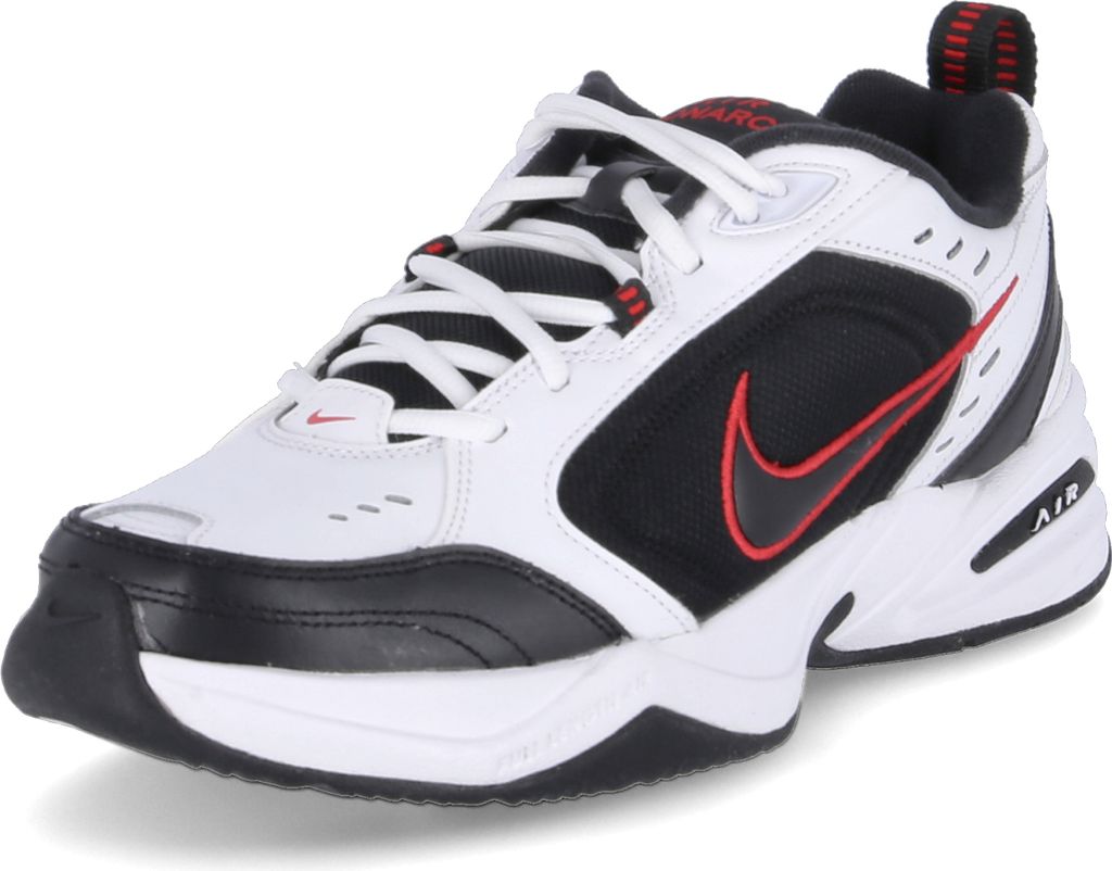 A white, black, and red Nike Air Monarch IV sneaker is shown from a side-angle on a white background.