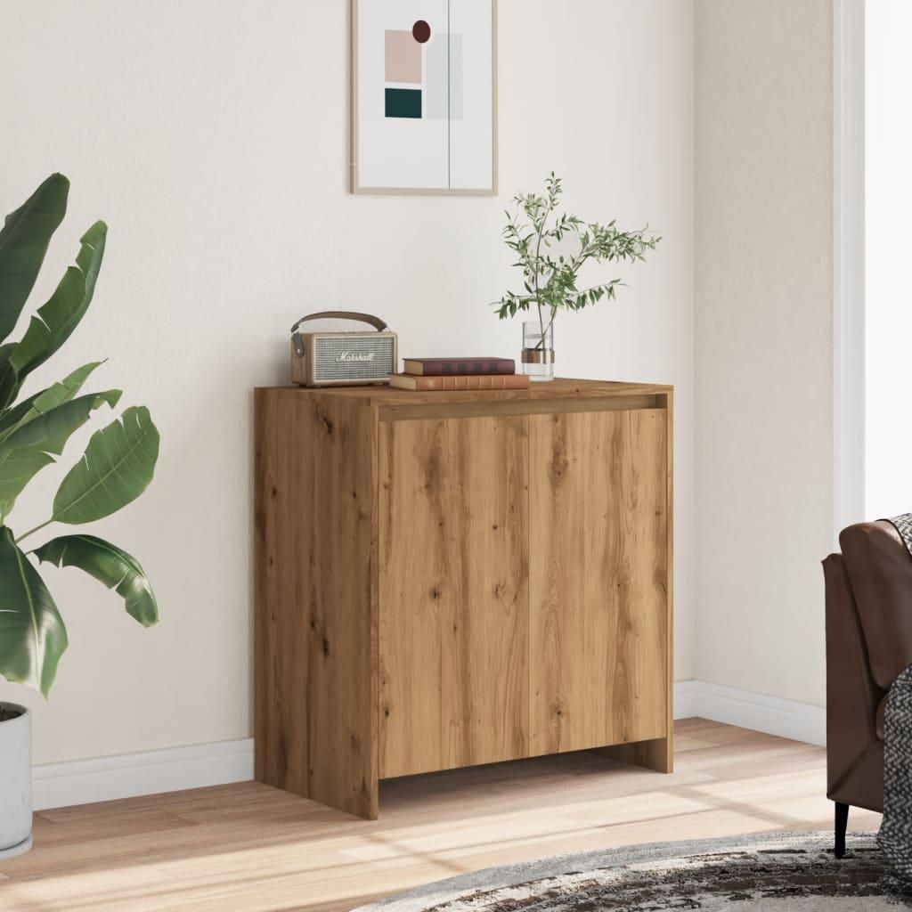 A wooden sideboard in a room with a plant and a framed picture on the wall.