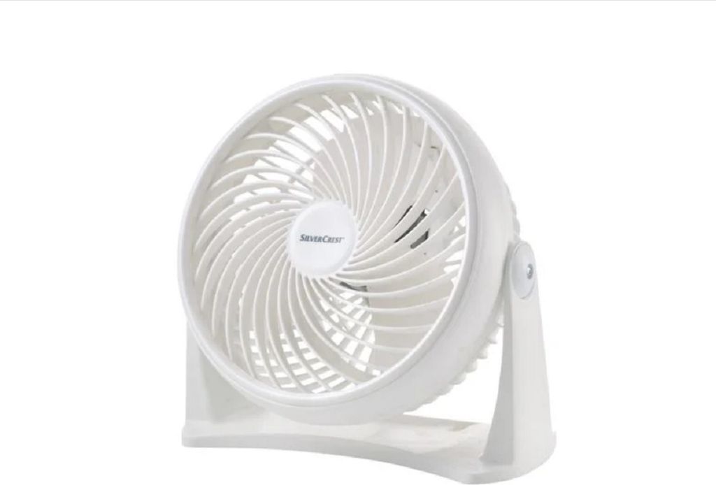 A white desk fan on a white background.