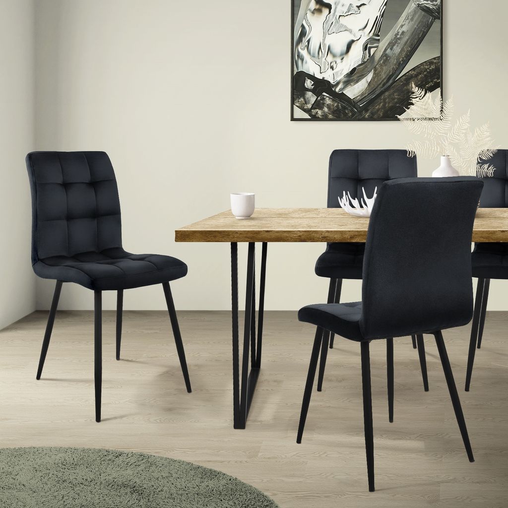A dining room scene with a table and chairs.