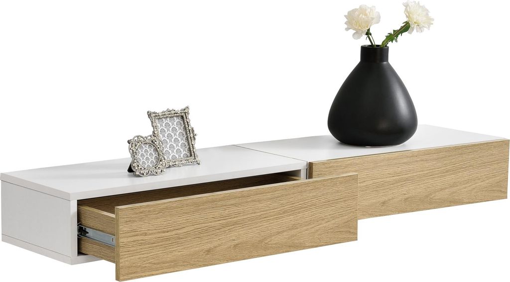 A white and wood-toned floating shelf with an open drawer and a black vase with flowers on top.