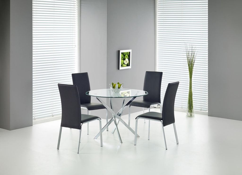 A dining table with four chairs in a modern room.