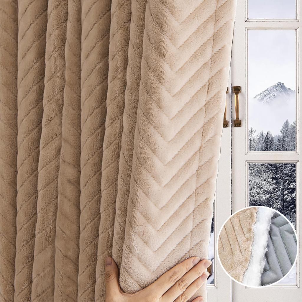 A hand is shown adjusting a thick, plush, beige curtain with a chevron pattern, which is hanging in front of a window showing a snowy mountain landscape. A close-up inset shows the texture and lining of the curtain.