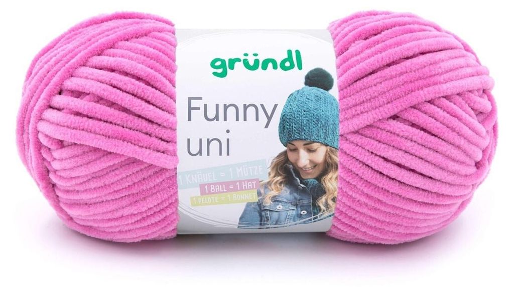 A ball of pink chenille yarn with a label showing a person wearing a teal knitted hat.