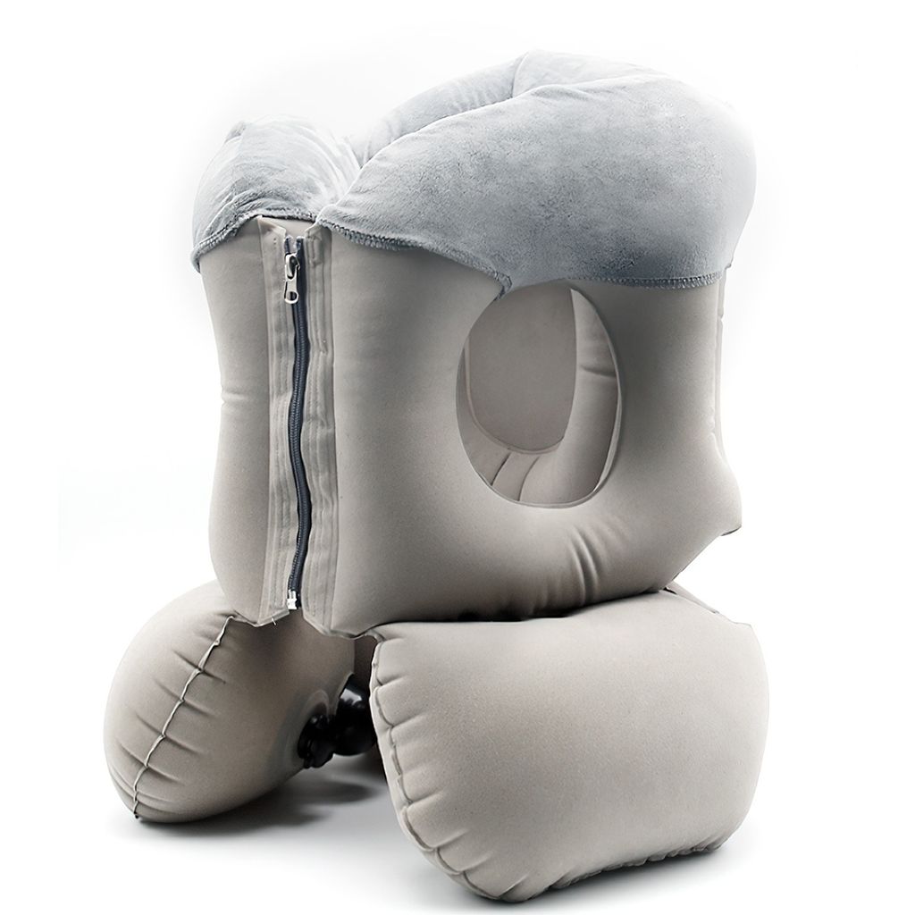 An inflatable travel pillow with a face hole and a zipper.
