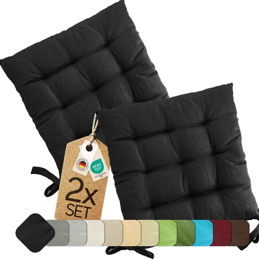 Two black seat cushions are displayed on a white background, with a tag indicating '2x SET' and various color swatches shown below.