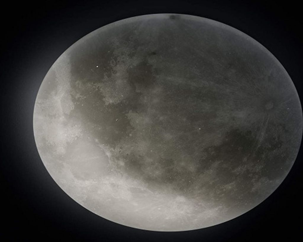 A close-up view of the moon against a black background.