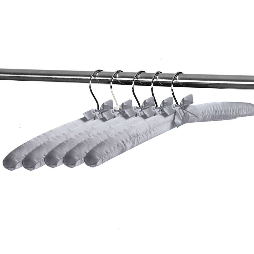 Several padded clothes hangers with bows are hanging on a metal rod.
