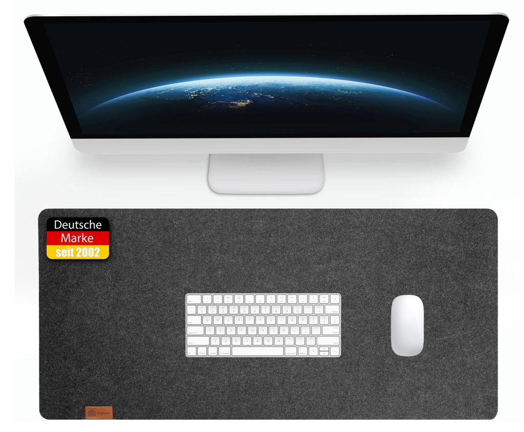 A computer monitor and a desk mat with a keyboard and mouse on it.