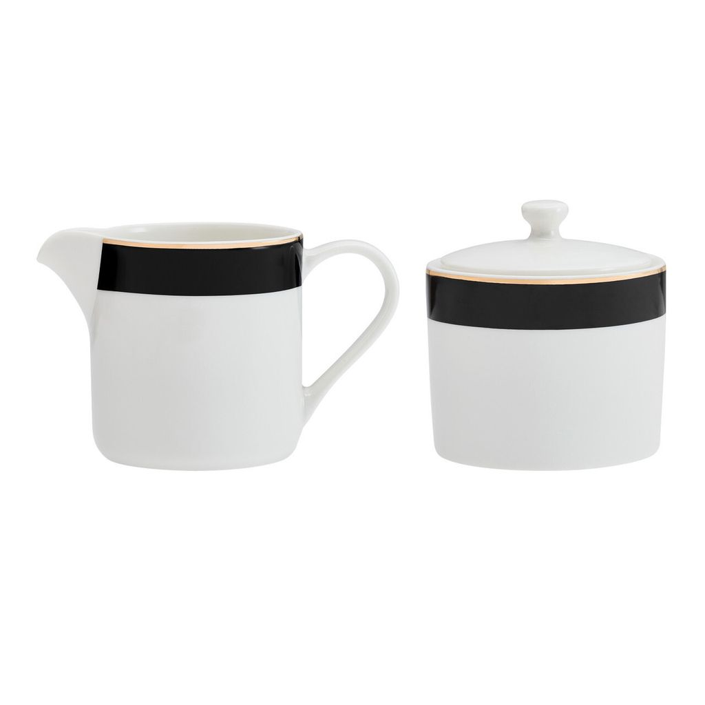 A white sugar bowl with a lid and a white creamer pitcher, both with a black band and a thin gold trim, are displayed against a white background.