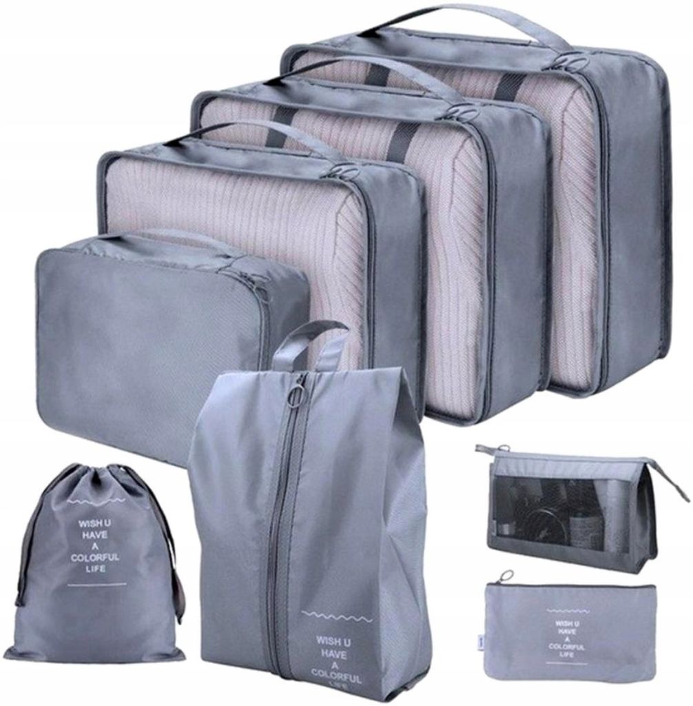 A collection of grey packing cubes and bags arranged in a visually appealing manner.
