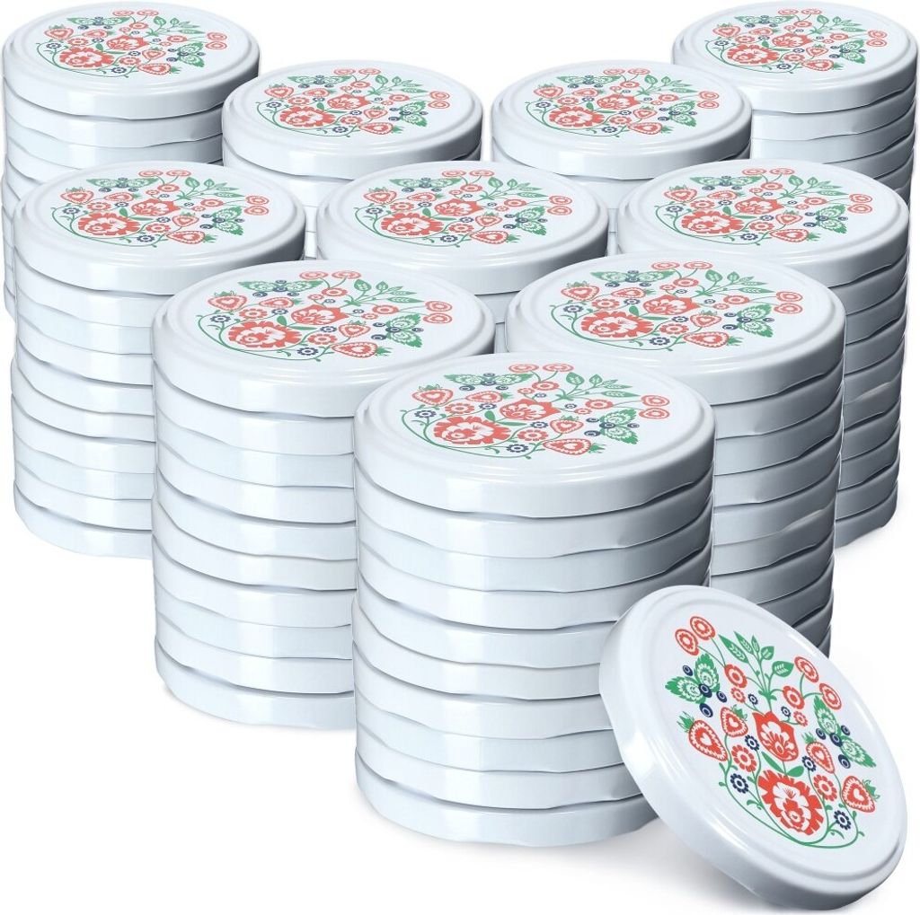 A stack of white jar lids with a floral folk art pattern.