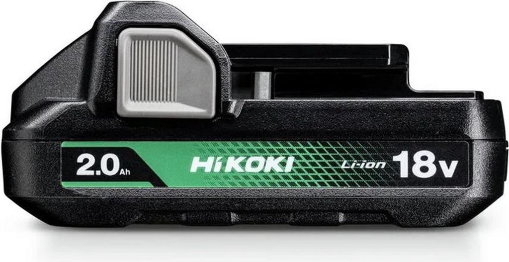 A black power tool battery pack with green and white branding.