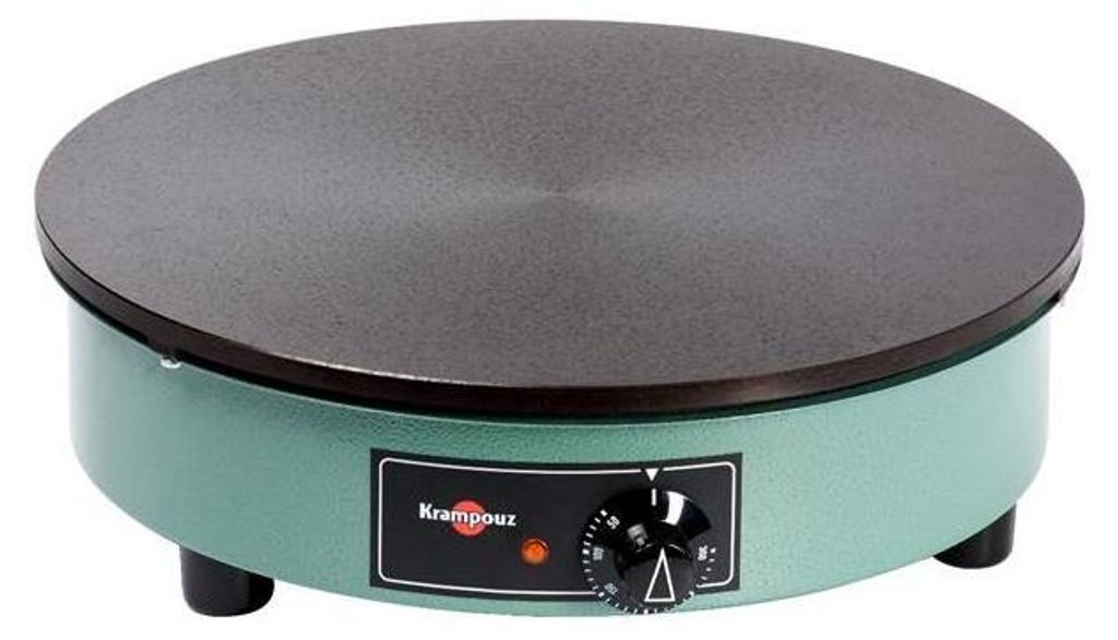 A green electric crepe maker with a black cooking surface.