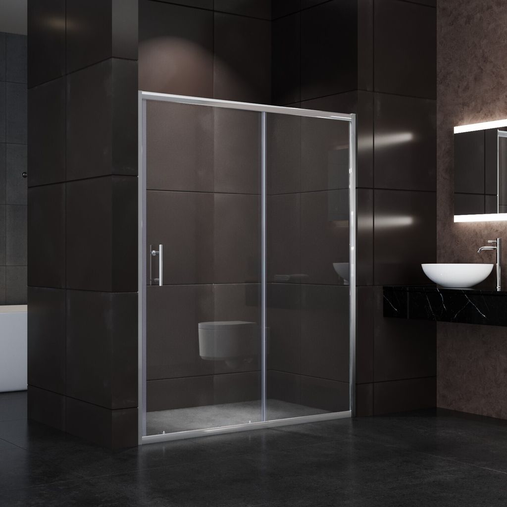 A modern bathroom with a glass shower door.