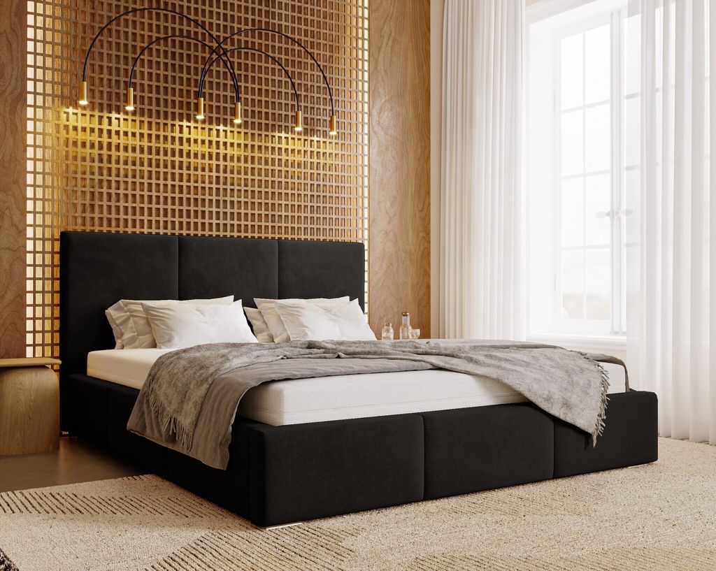 A modern bedroom with a black upholstered bed.