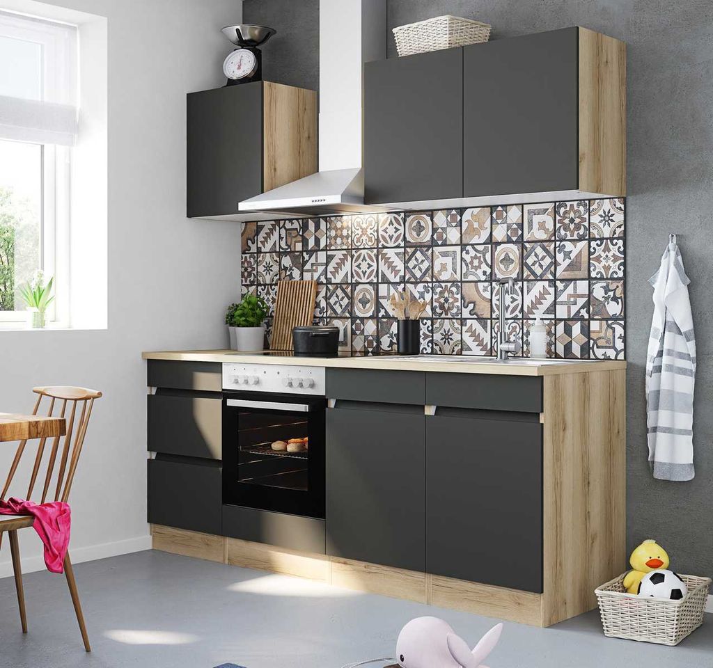 A modern kitchen setup with dark grey cabinets and wood accents, featuring a tiled backsplash and appliances.