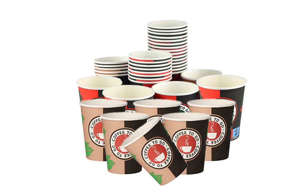 A collection of disposable coffee cups stacked and arranged.