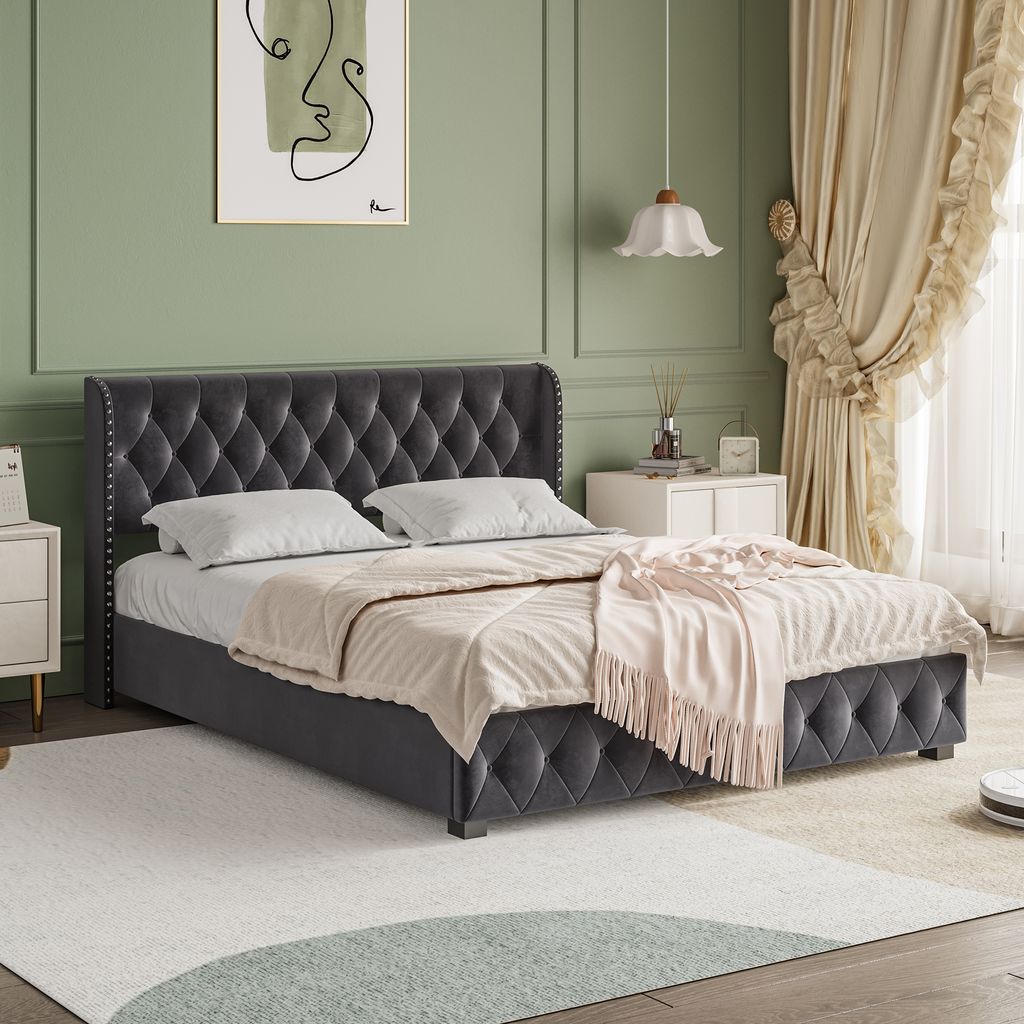 A bedroom scene with a bed as the main focus, decorated with curtains and a painting on the wall.