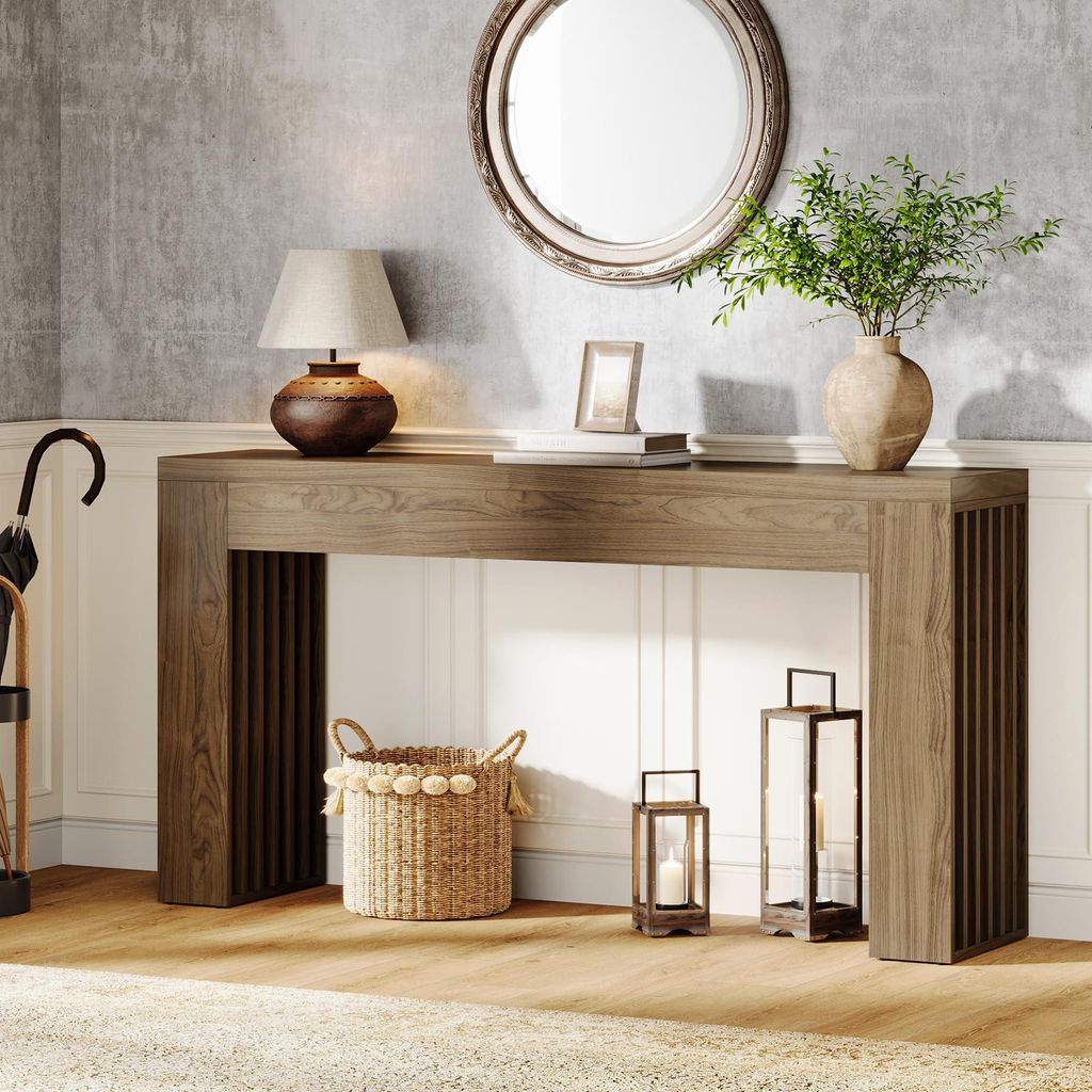 A console table in a hallway with decorative items.