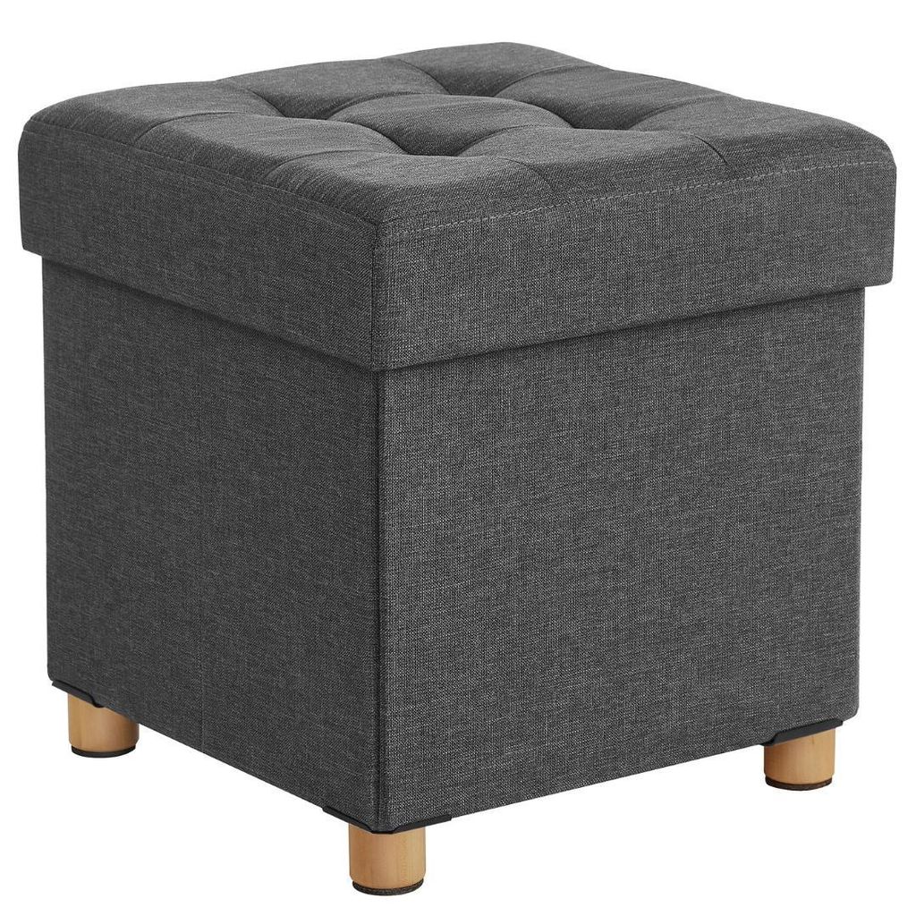 A dark gray upholstered storage ottoman with wooden legs is shown against a white background.