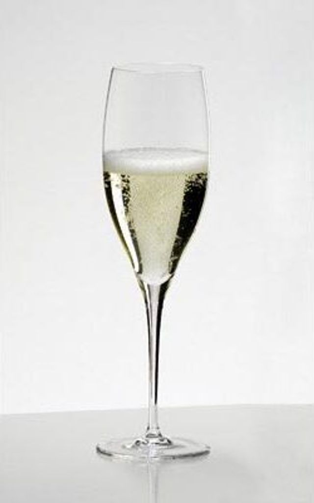 A single glass of champagne on a white background.