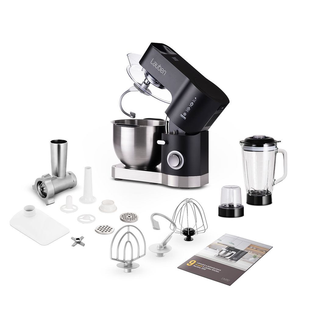 A black and silver stand mixer with various attachments, including a meat grinder, blender, dough hook, whisk, and beater, is displayed on a white background. A booklet is also shown.