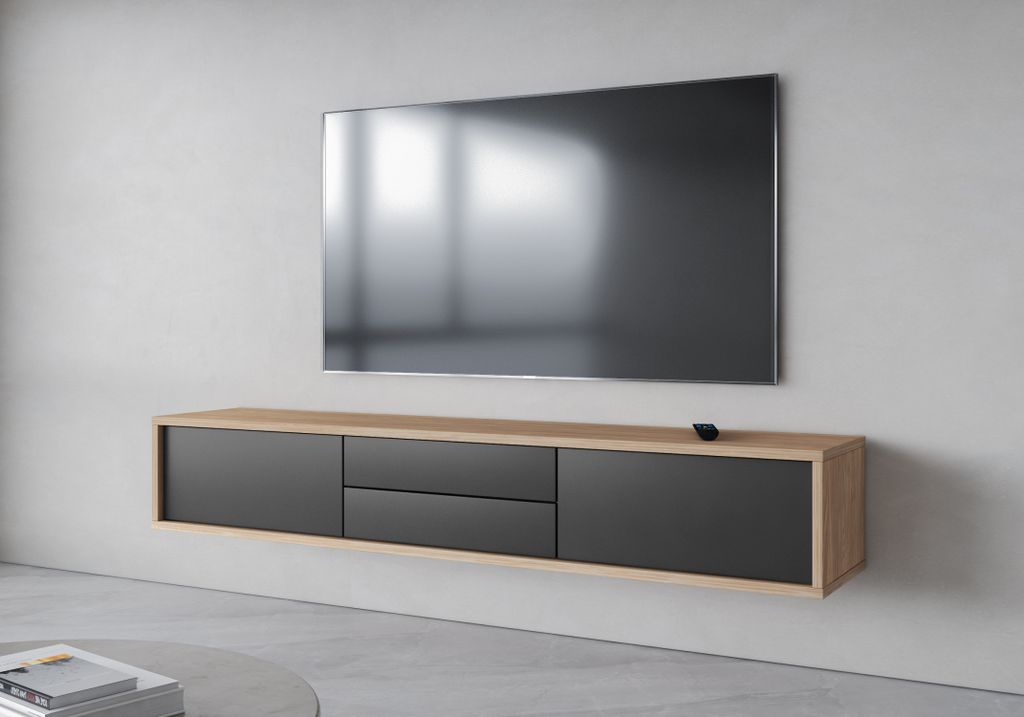 A modern, wall-mounted TV stand with drawers and a television mounted above it.