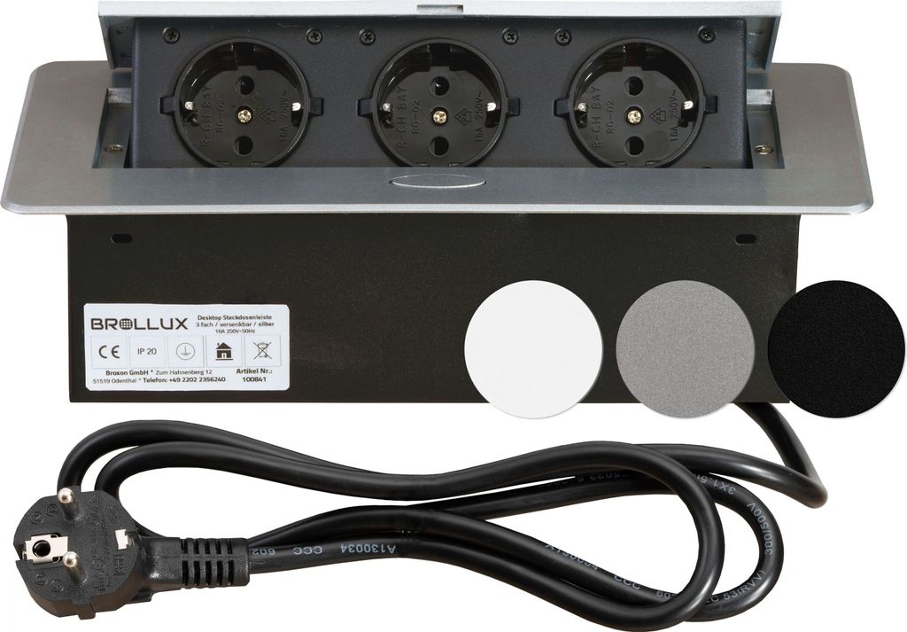 A pop-up power outlet with three sockets, a power cord, and sample covers for different colors.