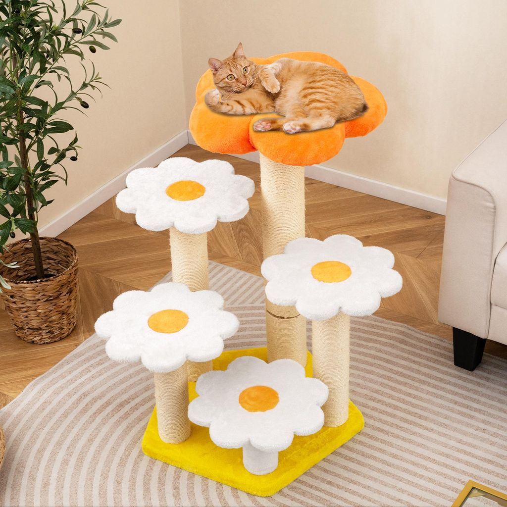 A cat is resting on a multi-tiered cat tree designed to look like flowers, placed in a room with a plant and furniture.