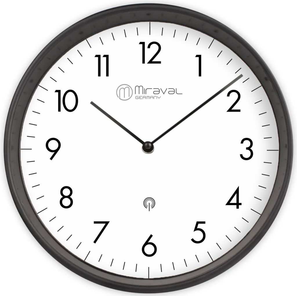 A close-up view of a wall clock with a white face, black numbers, and black hands.