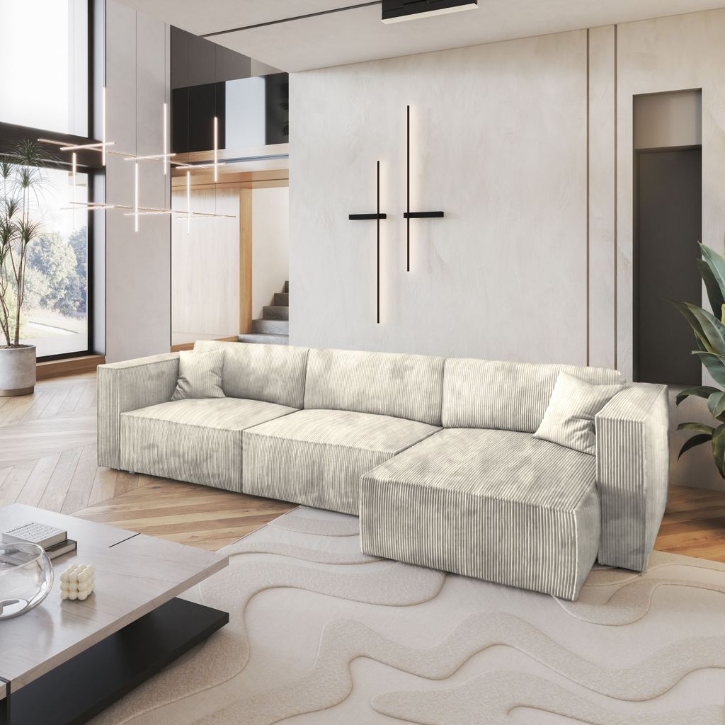 A modern living room with a large sectional sofa, coffee table, and abstract rug.