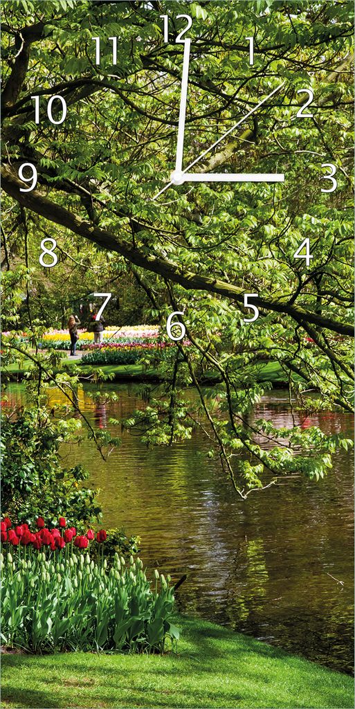Wallario Design Wanduhr Bunte Blumen im Park am Wasser - Frühblüher am Ufer aus Echtglas, Größe 30 x 60 cm