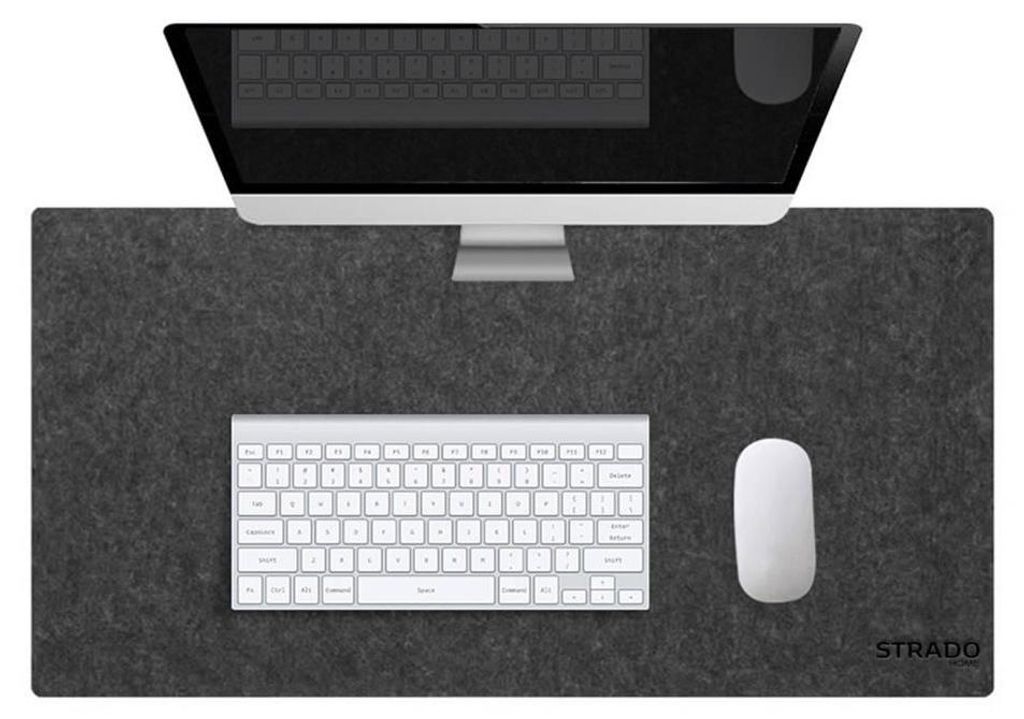 A desk setup with a computer monitor, keyboard, and mouse on a gray desk mat.