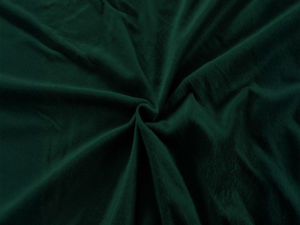 A close-up, top-down view of a crumpled dark green microfiber fabric, likely a bedsheet, with soft folds and shadows.