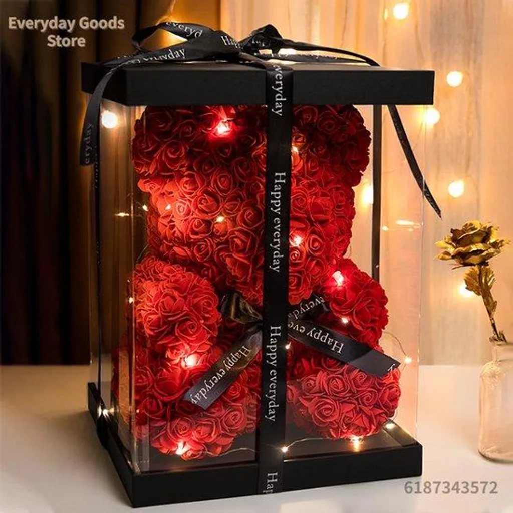 Décoration florale lumineuse avec roses rouges et peluche ours doux