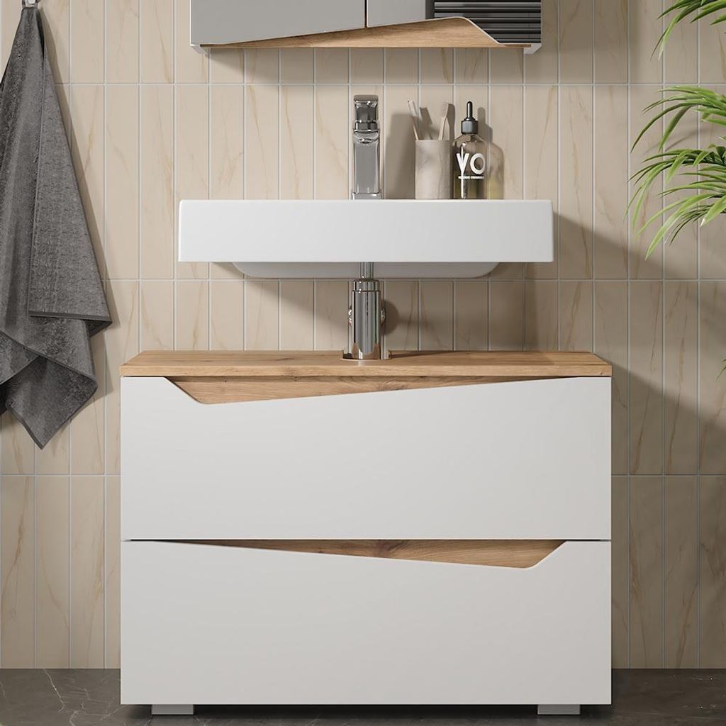 A modern bathroom vanity with a sink and two drawers, set against a tiled wall.