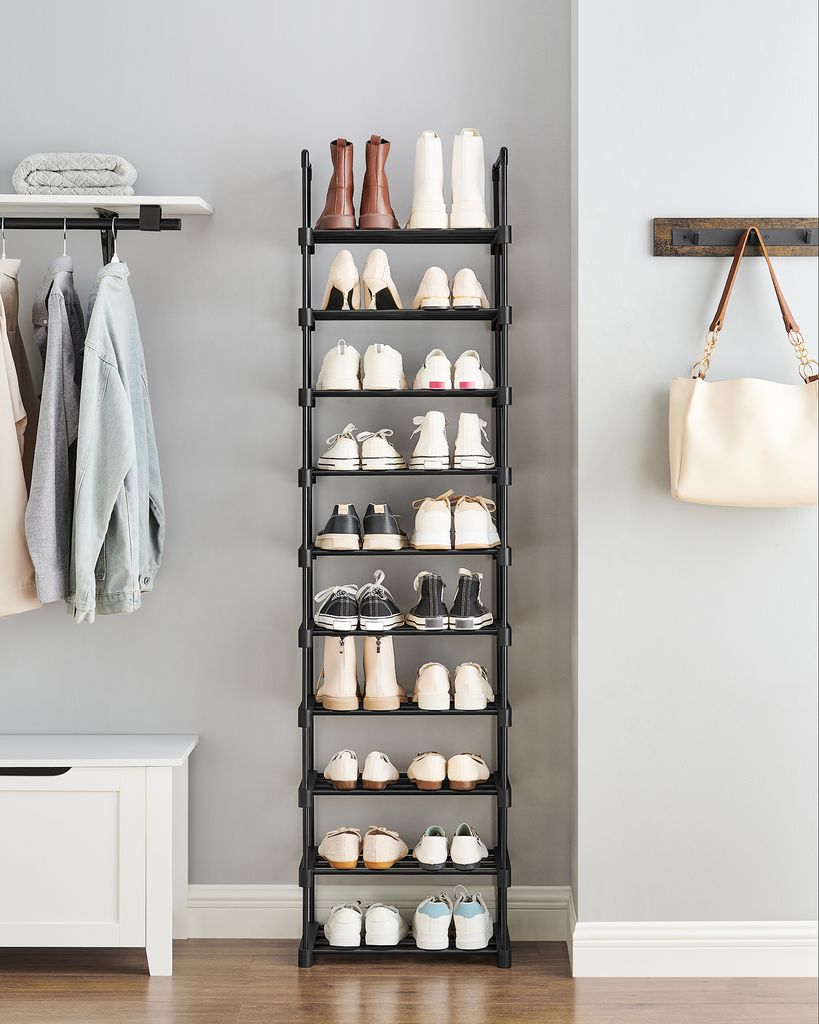 An entryway or hallway with a shoe rack, hanging clothes, and a chest of drawers.