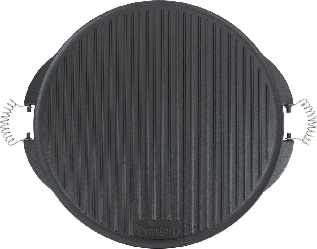 A top-down view of a round, black cast iron grill plate with raised ridges and two silver spring handles on the sides.