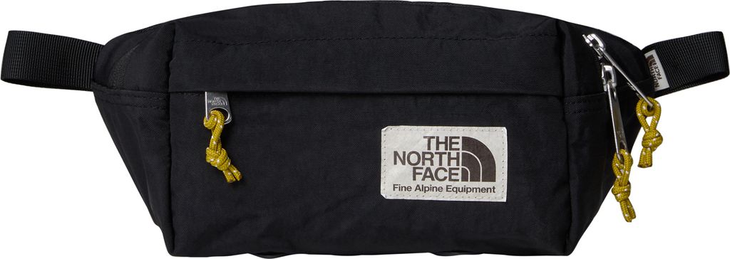 A black fanny pack with a white label and gold accents.