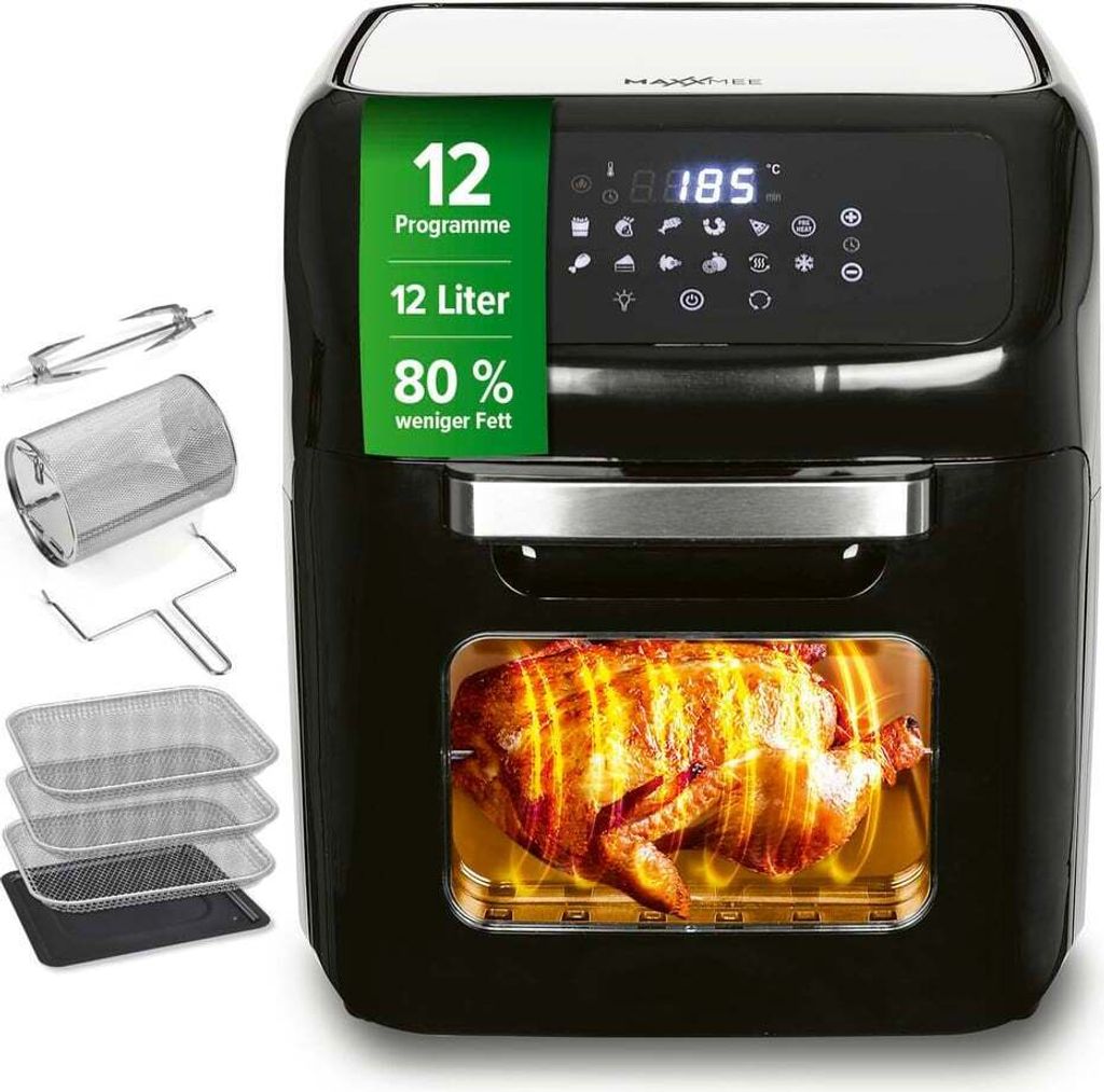 A black MAXXMEE air fryer with a rotisserie chicken inside, surrounded by its accessories.