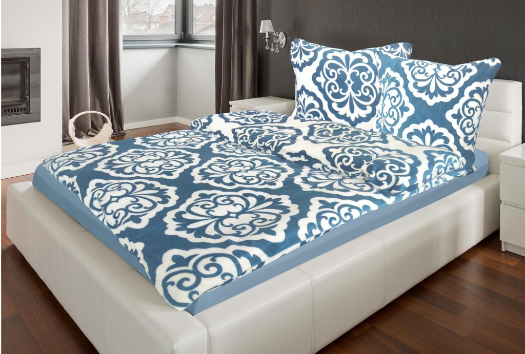 A bed with bedding in a bedroom setting.