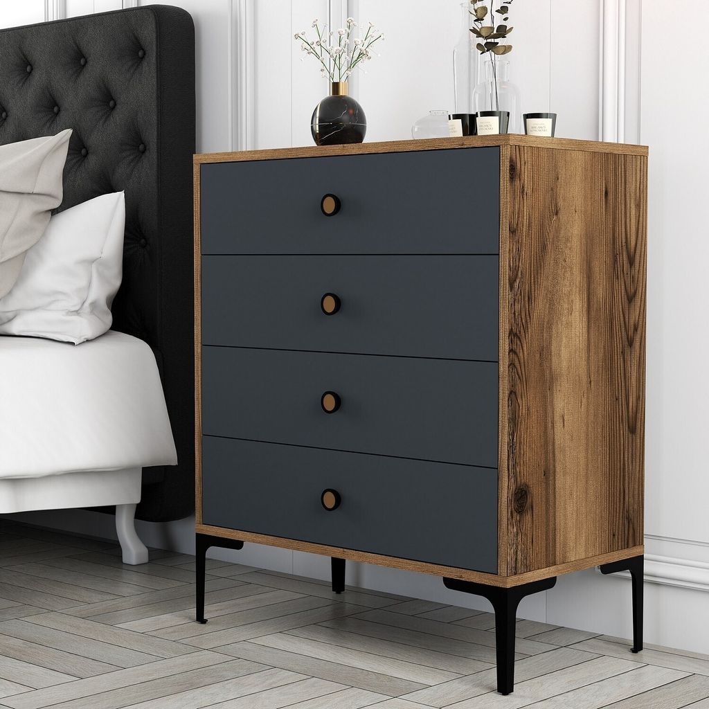 A bedroom scene with a dresser next to a bed.