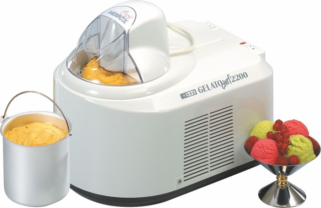 A white NEMOX Gelato Chef 2200 i-Green ice cream maker is shown with a metal container of ice cream, and a bowl of colorful ice cream scoops.