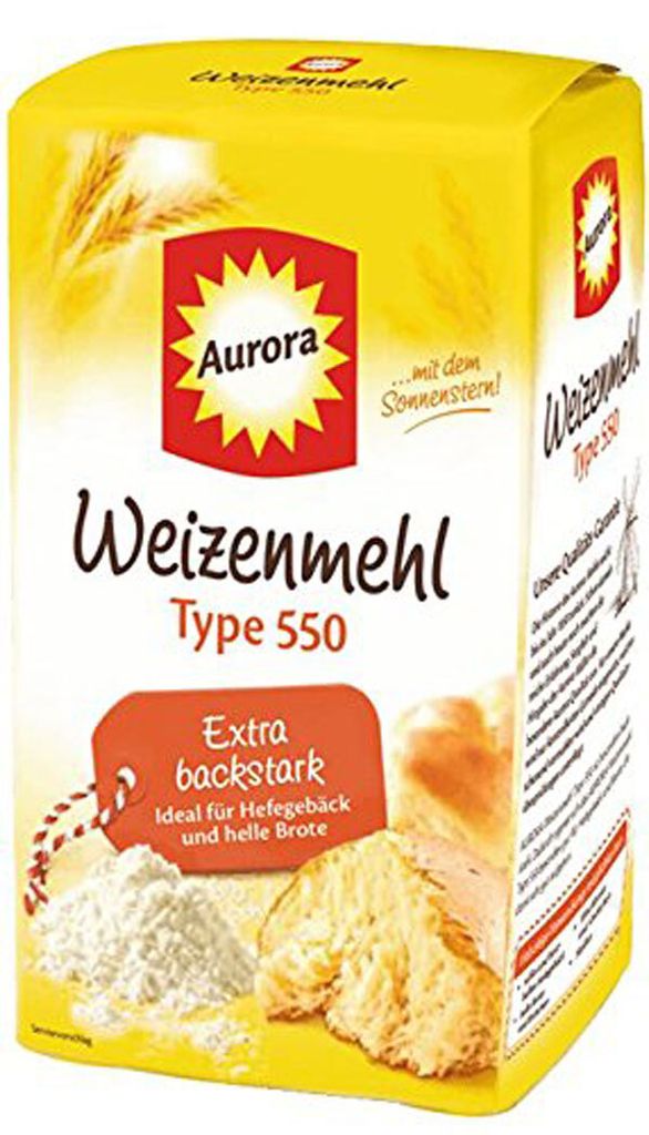 A package of Aurora Weizenmehl (wheat flour) Type 550, with images of wheat stalks, a sun logo, and baked goods.