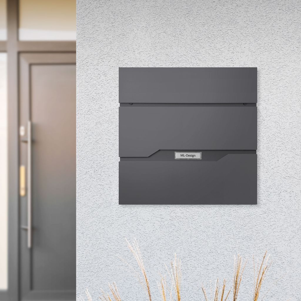 A modern mailbox mounted on a textured wall next to a doorway.