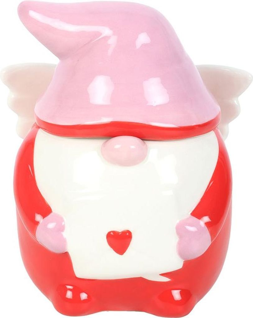 A ceramic gnome figurine with wings, holding a letter.