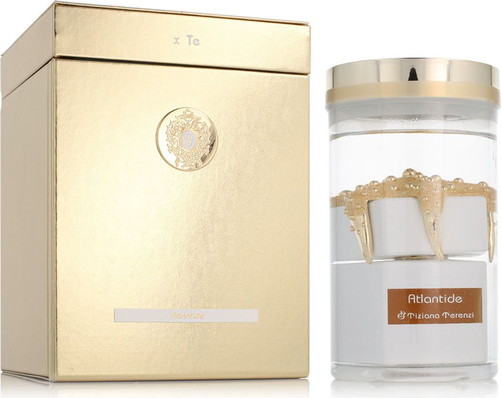 A gold box and a clear glass bottle with a perfume inside.