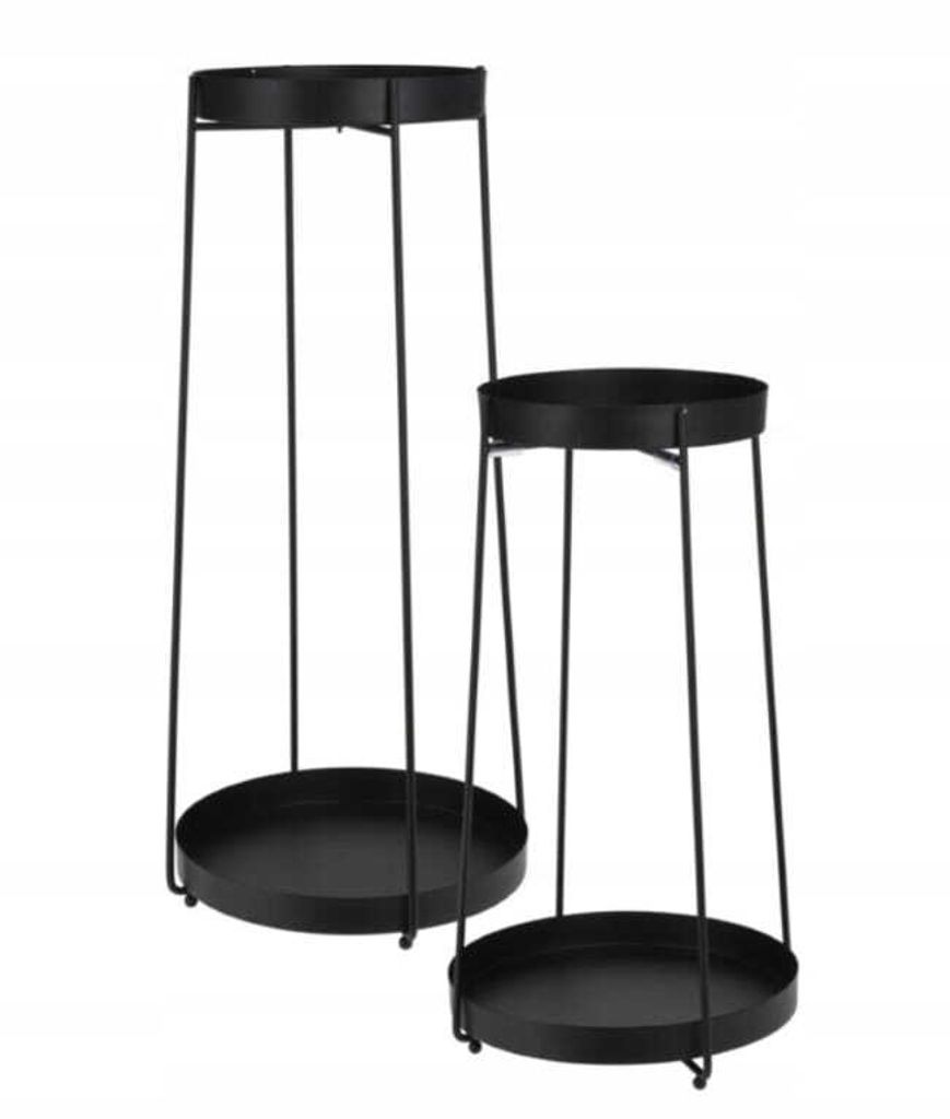 Two black metal plant stands of different heights.